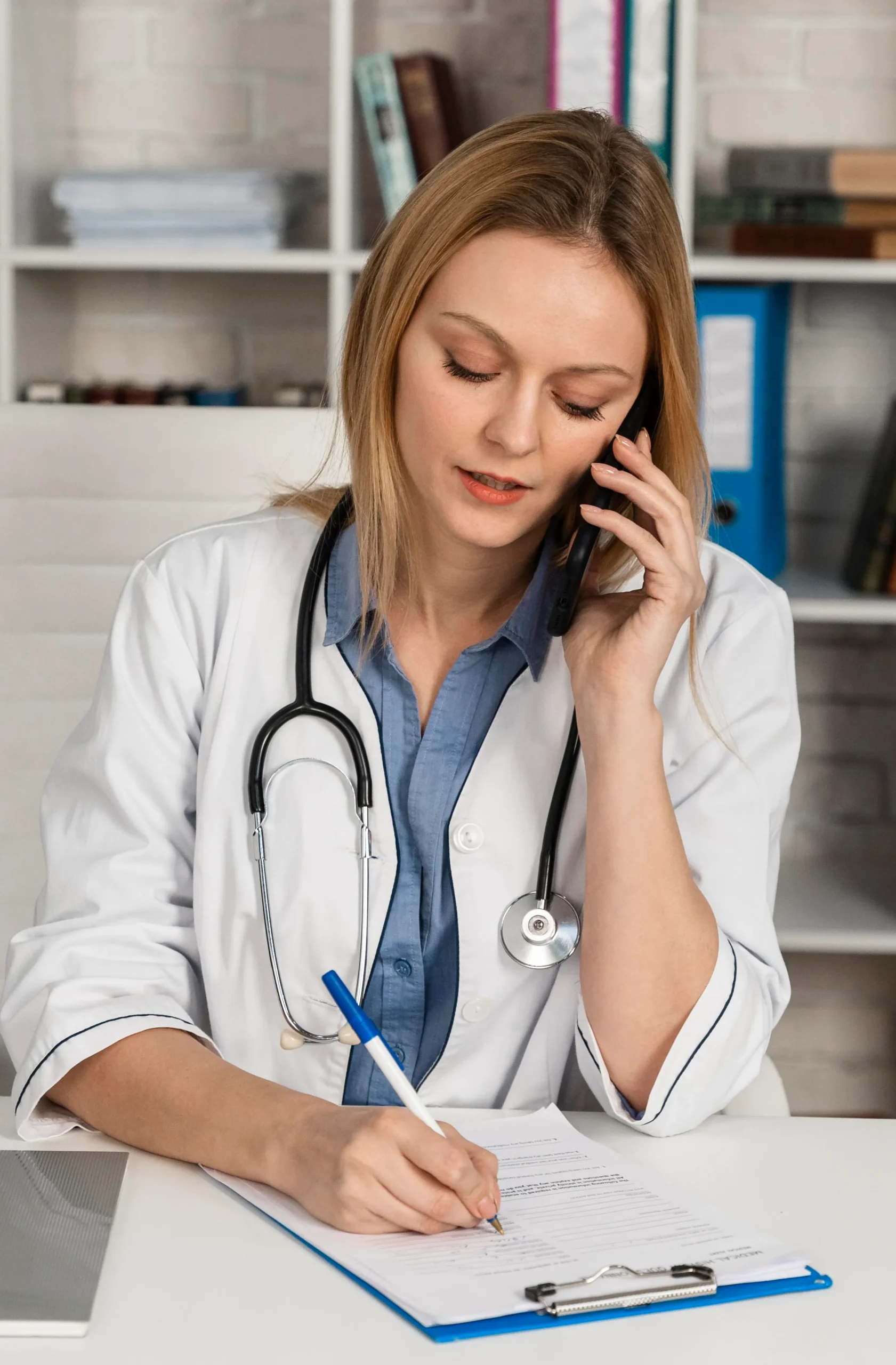 Physician at next level urgent care answering patient questions during a phone consultation.